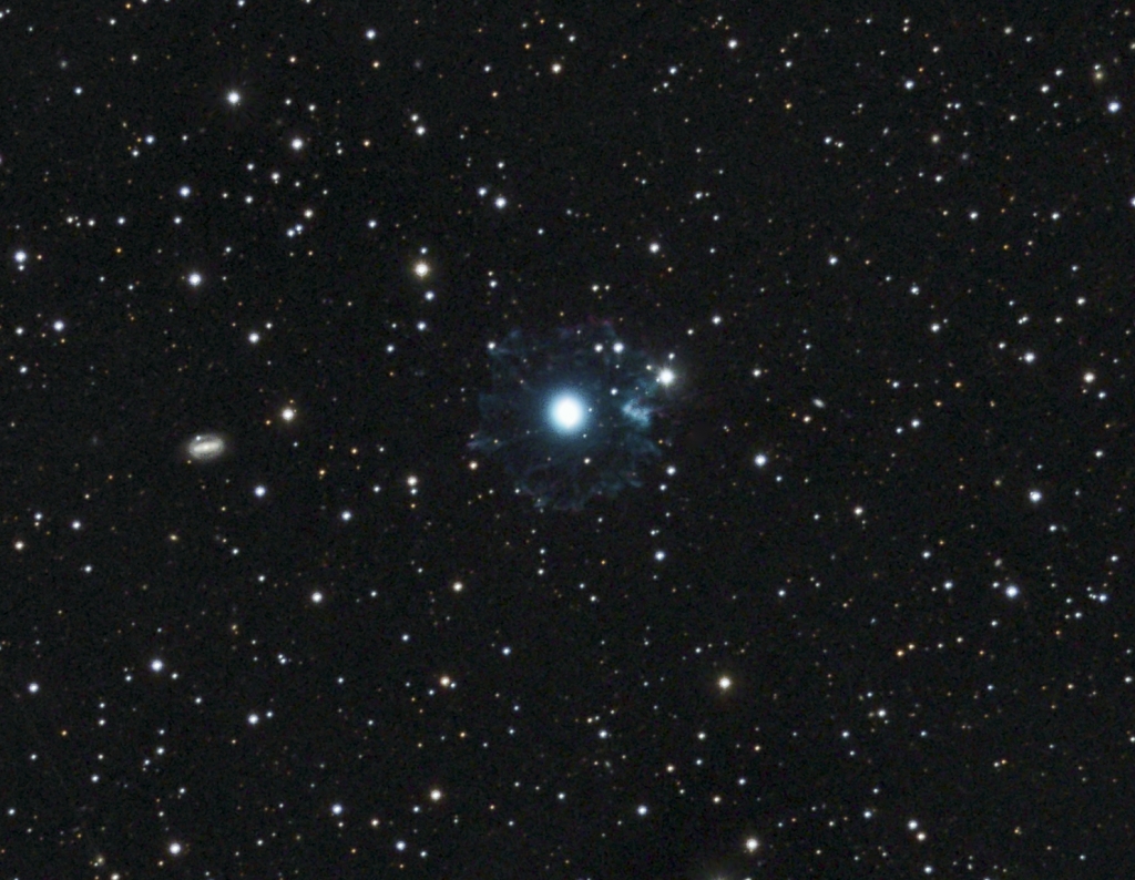 NGC 6543 - Cat's Eye Nebula
A structurally very complex planetary nebula about 3000 light-years from Earth in the constellation Draco.  In large-telescope images it has the appearance of a cat's eye, but in my 5" refractor it appears simply as a bright blue star with a halo.  The small spiral galaxy off to the left is probably NGC 6552.
