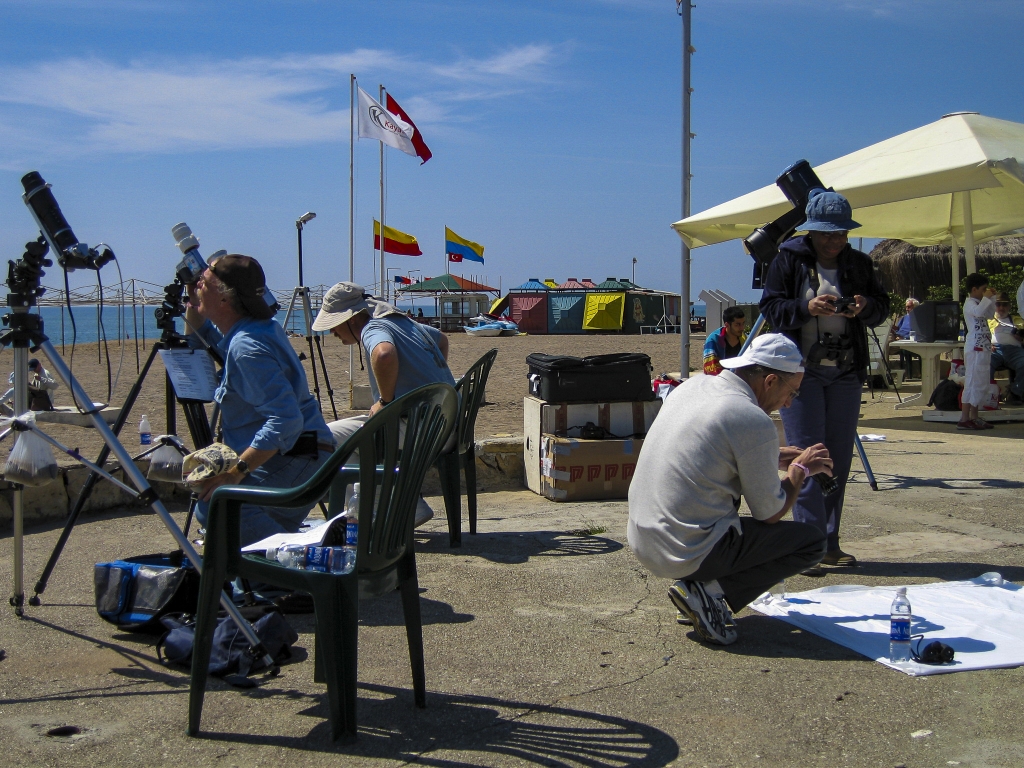 Halfway There
Rick Gering and Jim Windlinger keep tabs on the progress of the eclipse by monitoring their equipment, while Mike Treder and Pat Bush check out the projections on the sheet.
