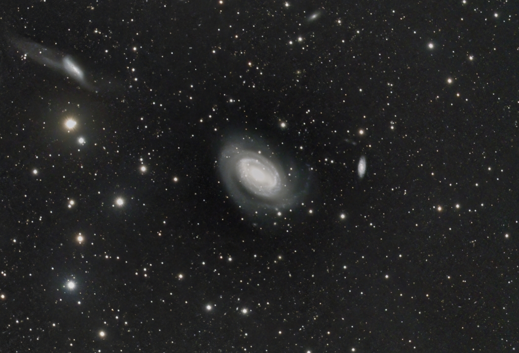 NGC 4725
A one-armed spiral galaxy in the constellation Coma Berenices, about 41 million light-years from Earth.  This is a Seyfert galaxy, meaning that it has a very active nucleus; it is also a barred spiral and has a prominent ring structure.  It is interacting with NGC 4747 in the upper left corner of the frame, resulting in severe distortion of both galaxies and producing the spectacular tidal tails seen with NGC 4747.  The smaller spiral galaxy to the right of NGC 4725 is NGC 4712.  
