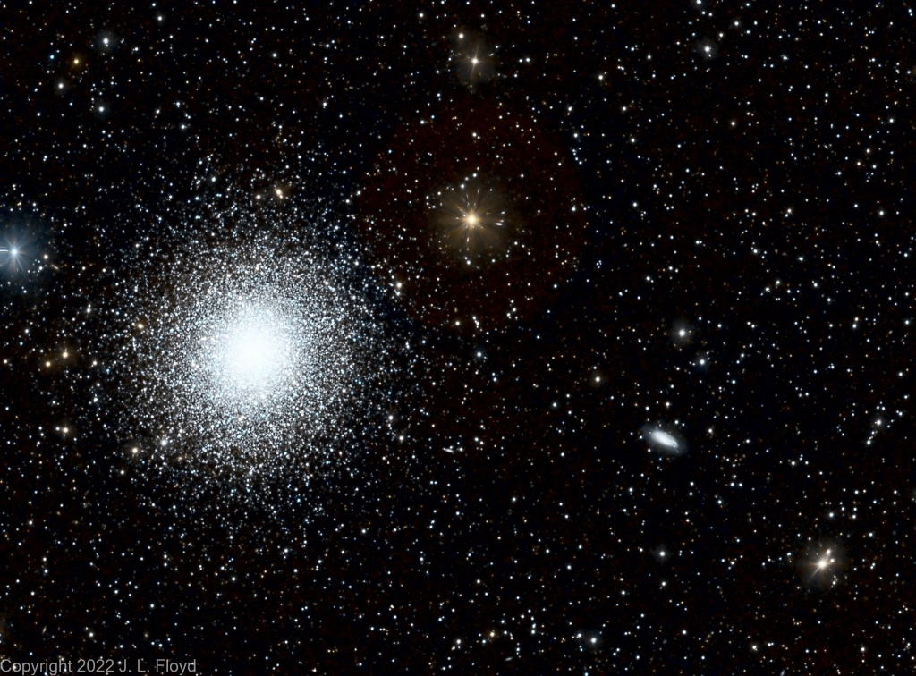 NGC 6207, Spiral Galaxy in Hercules
NGC 6207 is the small oval object on the right side of the photo, just below the centerline.  It is seen nearly edge-on and is about 30 million light-years from Earth.  It is somewhat outshone by M13, the large globular cluster on the left, which is of course much closer, at 22,200 light-years from Earth.  
