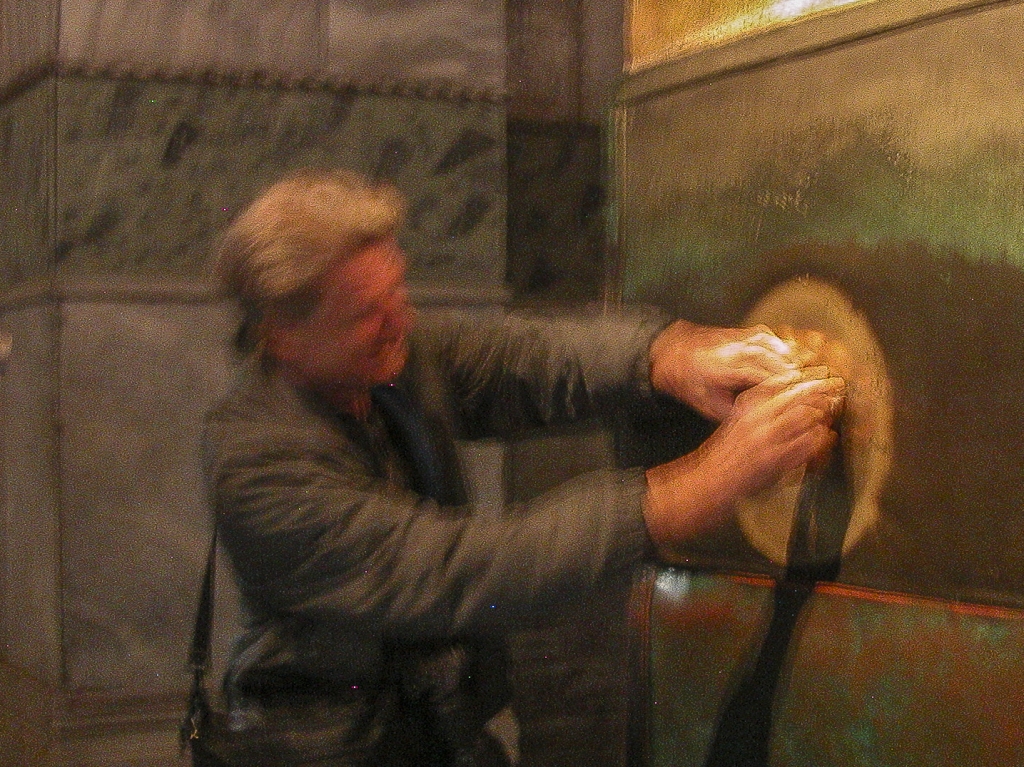 Trying His Luck
David Lindquist tries his luck at the Wishing Column.  According to the legend, many people have been cured of illness after touching this column.  David wasn't sick at the time, so this was not a valid test of that part of the legend.
