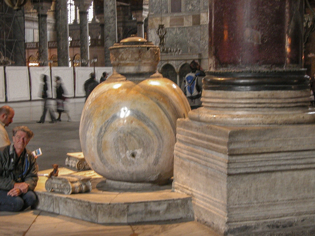 Lustration Urn
David Lindquist with his mascot bear Hero kneels next to one of two huge urns carved from single blocks of marble.  They date from the Hellenistic era - 300 BC or so - but were brought here from Pergamon during the reign of Sultan Murad III (r. 1574-1595).
