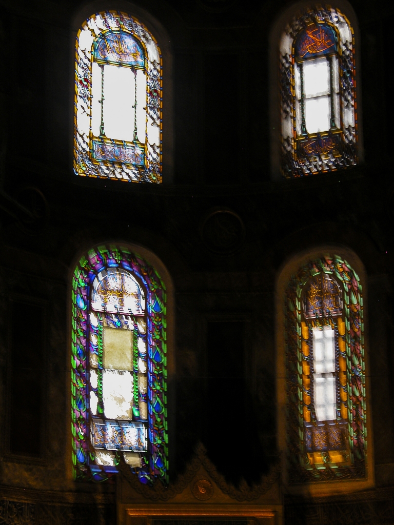 Colorful Windows
Four of the stained-glass windows admitting light into the apse.
