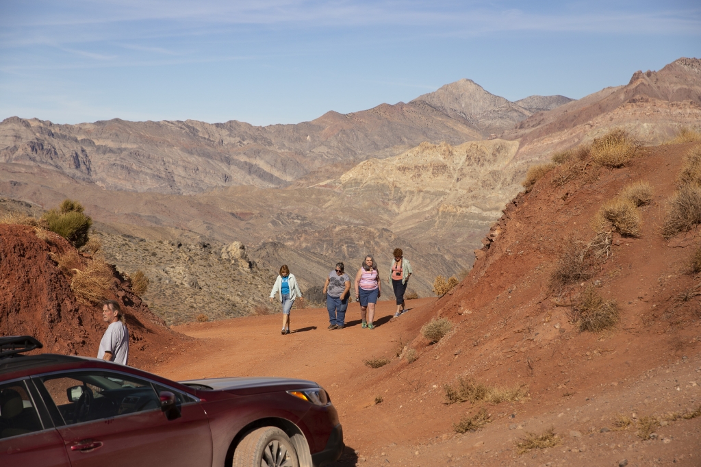 Red Pass
Mike hangs out by Red Sonja while the girls go for a stroll.  Check out the varicolored rock strata in the background hills.
