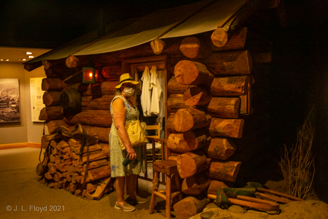 Life on the Frontier
A pioneer woman preparing to enter her log cabin in the backwoods of the Pacific Northwest.  It was customary in those days to wear masks to ward off diseases such as smallpox and tuberculosis.
