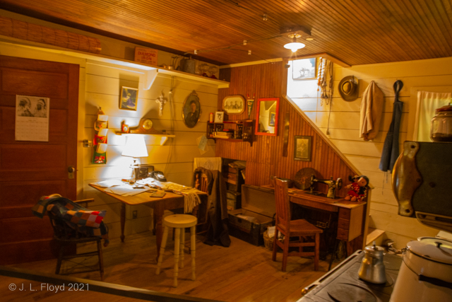 Business as Usual
A home office of the nineteenth century West, featuring a sewing machine, drafting desk and wood stove instead of a computer and microwave oven.
