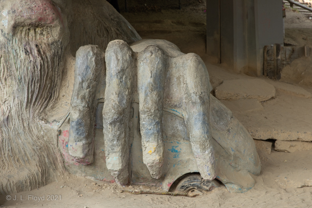 The Gripping Hand
I finally was able to get an unobstructed view of part of the troll:  his hand.  It's grasping a wrecked VW Beetle - a real one.
